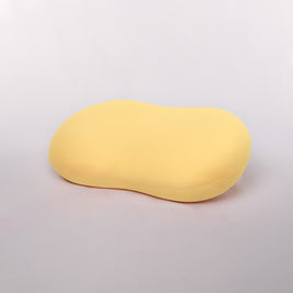 Yellow oval object on a light gray background